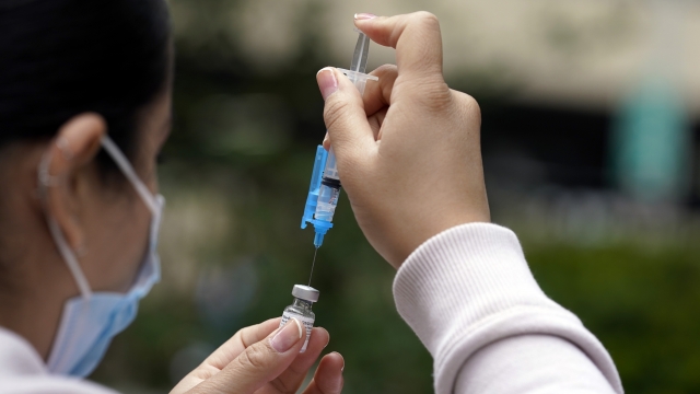 A shot of the Pfizer COVID-19 vaccine is prepared