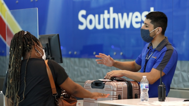 A Southwest Airlines employee assists a passenger at the ticket counter