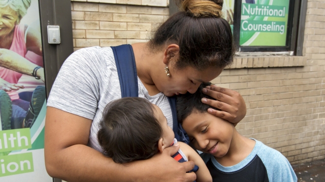 Honduran mother Eilyn Carbajal hugs her sons after being reunited