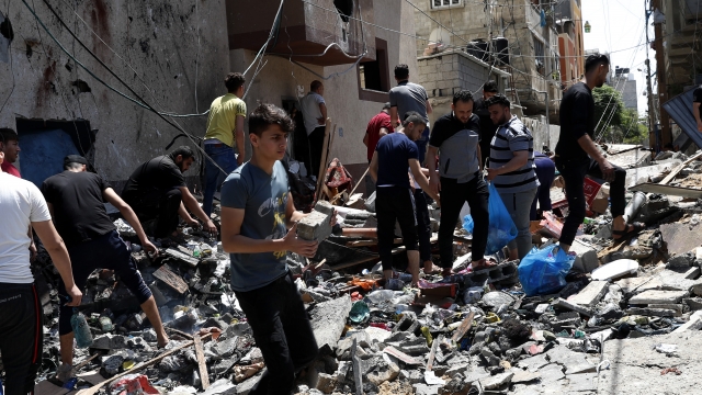 People inspect rubble of destroyed building