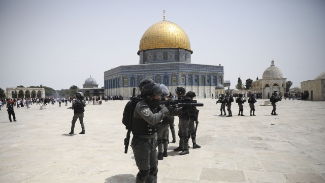 Israeli police clear Palestinians from the plaza at al-Aqsa mosque complex in Jerusalem.