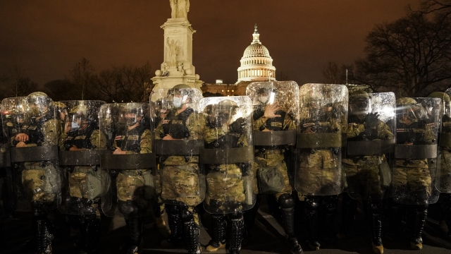 District of Columbia National Guard stand outside the Capitol, after a day of rioting protesters.