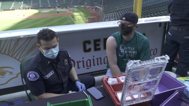 Baseball fan gets vaccinated