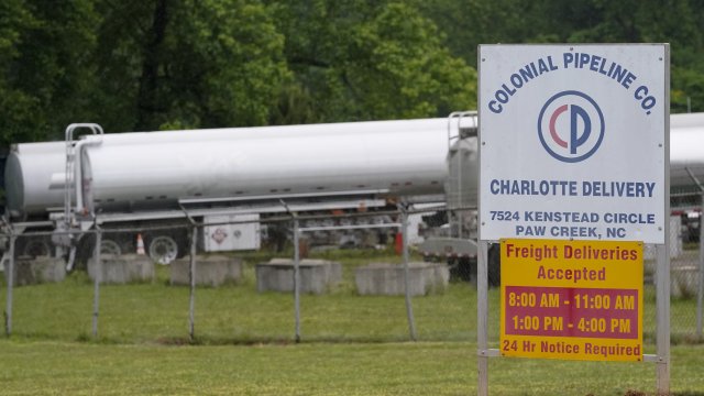 Tanker trucks are parked near the entrance of Colonial Pipeline Company