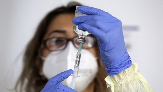 A nurse prepares to administer a dose of the Pfizer-BioNtech COVID-19 vaccine.