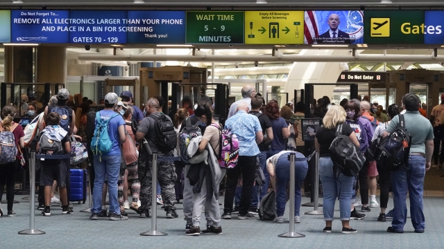 Travelers line up to go through a TSA checkpoint at Orlando International Airport