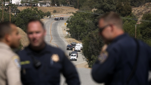 Law enforcement authorities close off a road during an investigation for a shooting at fire station 81 in Santa Clarita, CA