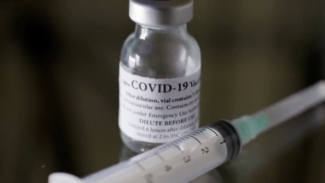 COVID vaccine sits on a table.