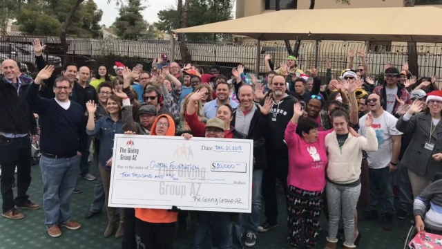 Group poses with a giant check.