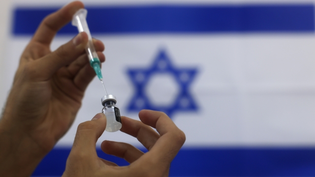 Israeli military paramedic prepares a Pfizer COVID-19 vaccine,