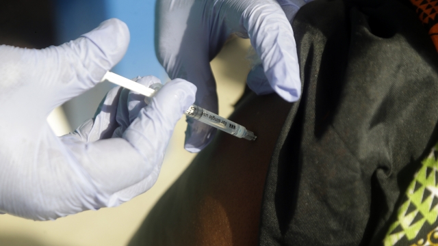 Health care worker administering a COVID-19 vaccine.