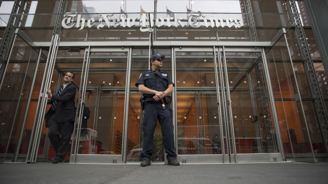 A police officer stands outside The New York Times building in New York.