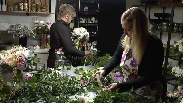 Women work in a flower shop.