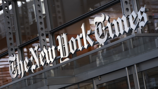A sign for The New York Times hangs above the entrance to its building in New York.