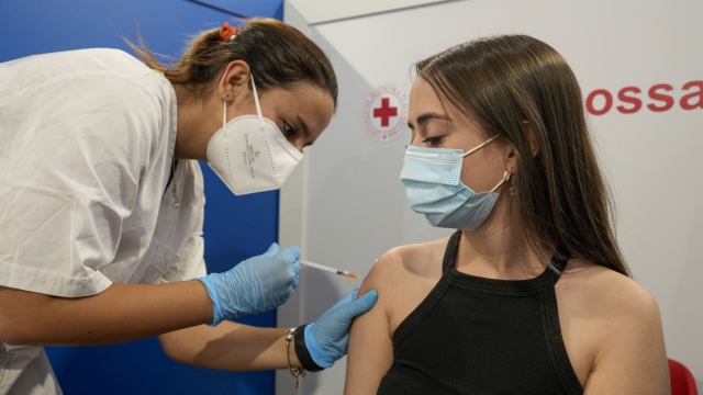 A student is administered their first dose of a COVID-19 vaccine.