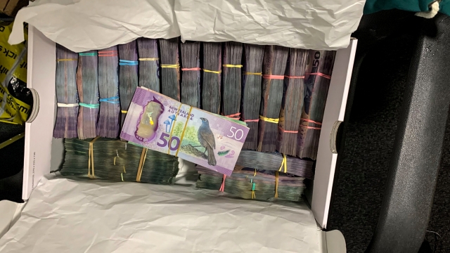 A box containing a large amounts of cash is seen after being discovered during a police raid as part of Operation Trojan.