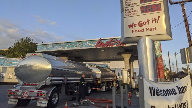 A fuel truck driver checks the gasoline tank level at a United Oil gas station in Sunset Blvd., in Los Angeles.