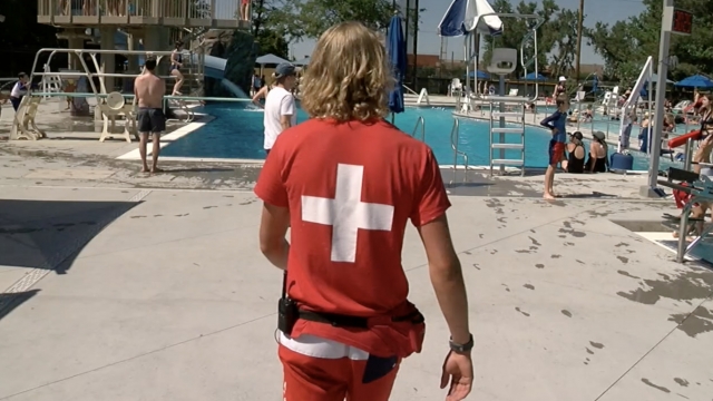Lifeguard walks to the pool.