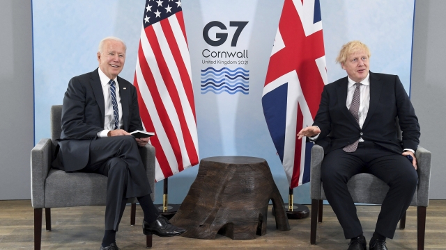 US President Joe Biden, left, poses for a photo with Britain's Prime Minister Boris Johnson, during their meeting