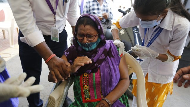A disabled woman gets a dose of India's version of the AstraZeneca vaccine.