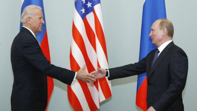 Then Vice President shakes hands with Russian Prime Minister Vladimir Putin in 2011.