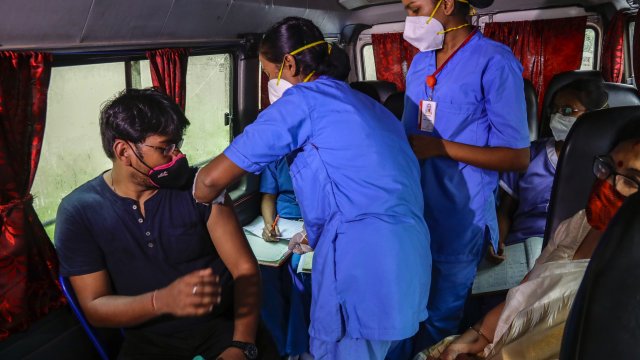 A health worker administers Covishield, Serum Institute of India's version of the AstraZeneca vaccine in Kolkata, India.