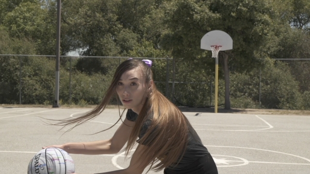 Woman plays basketball
