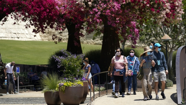 Visitors wear mask while walking through a garden
