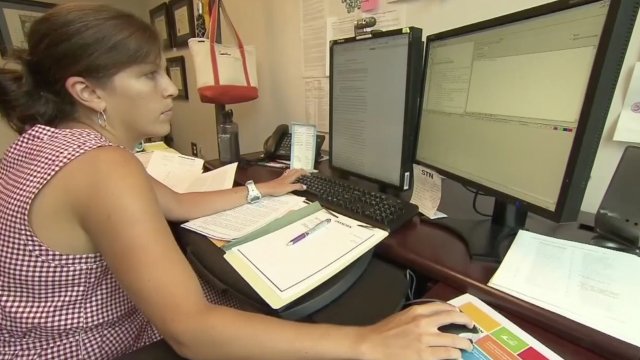 Woman works at a computer.
