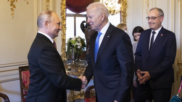 Russian President Vladimir Putin shakes the hand of U.S. President Joe Biden.