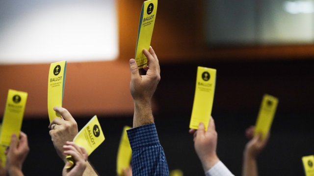 People signify their vote on a motion during the annual Southern Baptist Convention