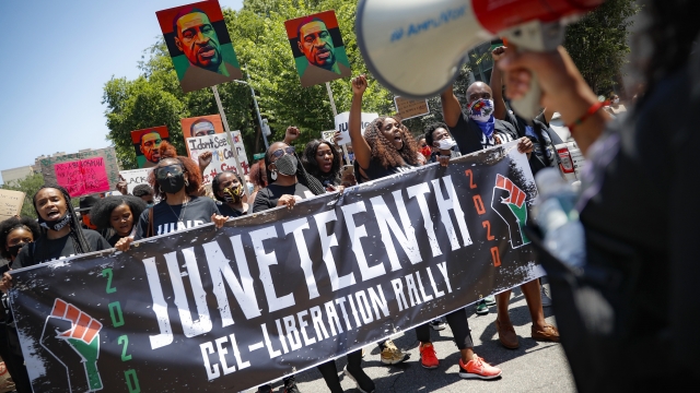 Protesters chant as they march after a Juneteenth rally at the Brooklyn Museum