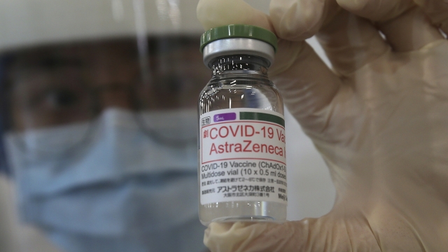 A health worker holds a bottle of the AstraZeneca COVID-19 vaccine.