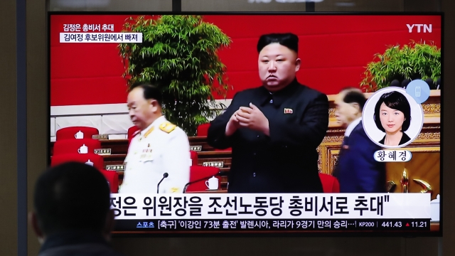 A man watches a TV screen showing a footage of North Korean leader Kim Jong Un.
