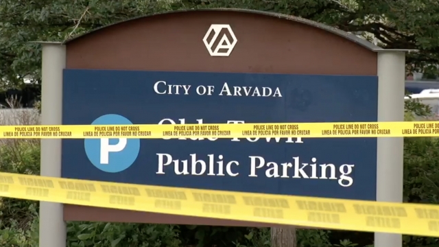 Police tape covers a city sign.