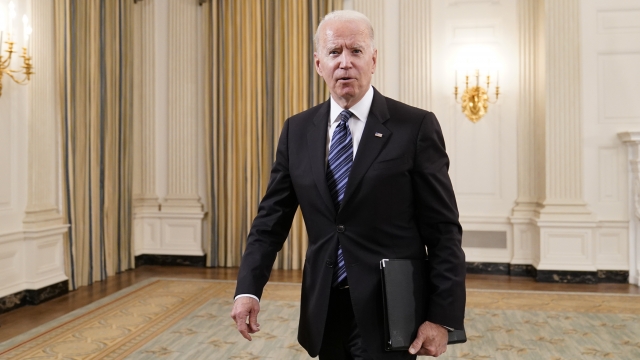 President Joe Biden walks out of the State Dining room
