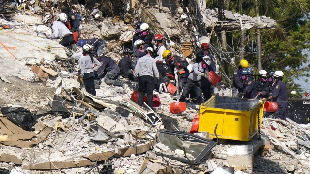 Rescue workers search in the rubble