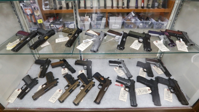 Semi-automatic handguns are displayed at shop