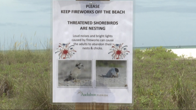 Sign says to keep fireworks off the beach.