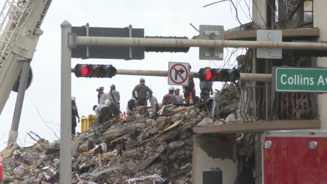 First responders work at collapse site.