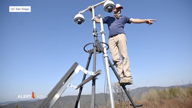 Man uses technology to survey land.