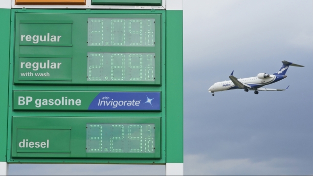 Gas prices are displayed as a jet descends to land at Cleveland Hopkins International Airport in Cleveland