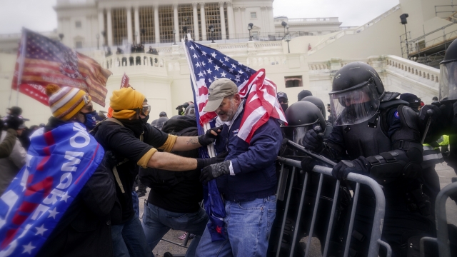 Rioters try to break through a police barrier at the Capitol on Jan. 6, 2021, in Washington, D.C.