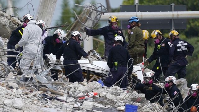 Rescue workers transporting remains found at the site of the collapsed Champlain Towers South condo in Surfside, Florida.