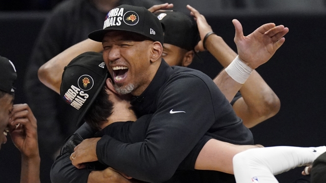 Phoenix Suns head coach Monty Williams, right, hugs Dario Saric after they won Game 6.