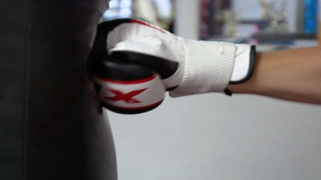 A boxer punches a bag.
