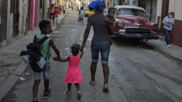 A Cuban family walks through Havana