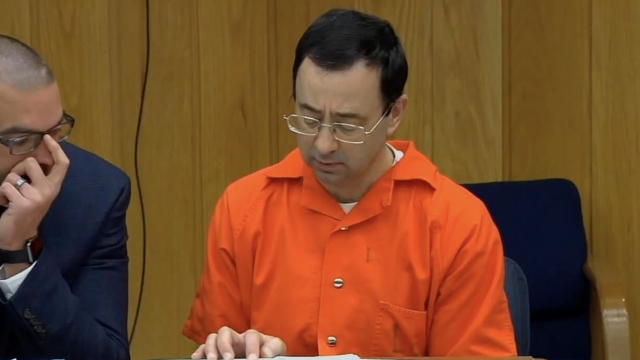 Larry Nassar sits in a courtroom.