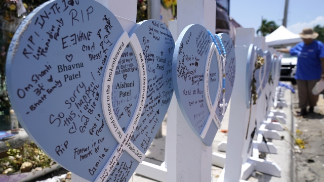 A wooden heart at a makeshift memorial remembers some of the lives lost in the collapse of the Champlain Towers South.