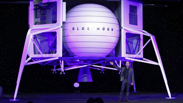 Jeff Bezos speaks in front of a model of Blue Origin's Blue Moon lunar lander
